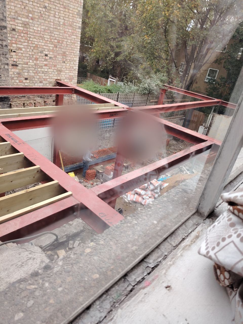 New walls being built up alongside the steel frame
